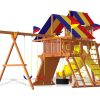 Large cedar Rainbow Play System installed in a family backyard with swings and slides